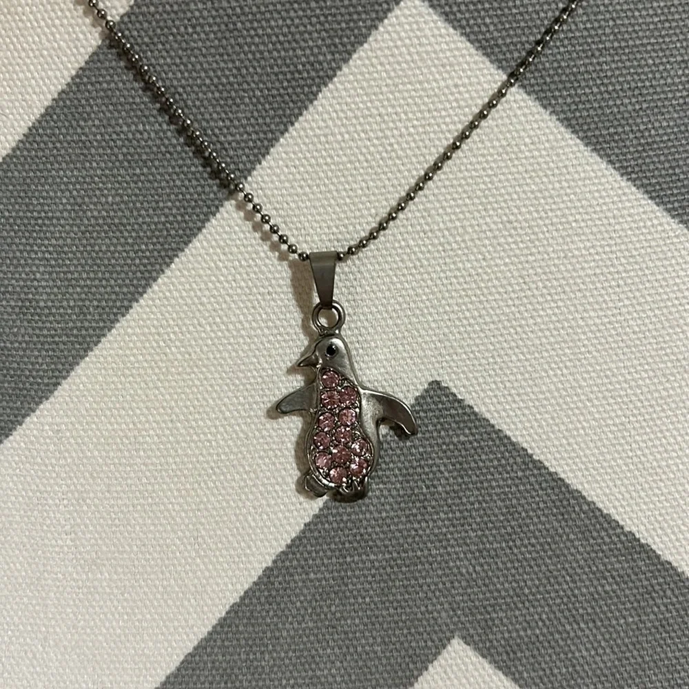Kids 16” silver necklace with 2” extender. Has a silver penguin pendant. Used